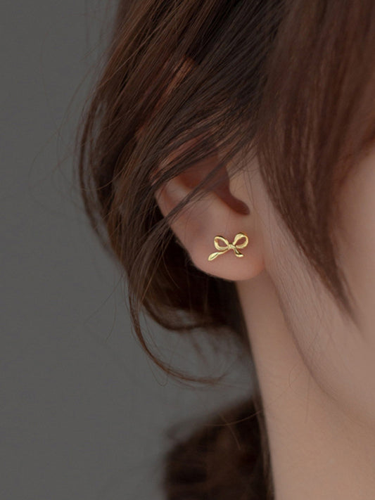 Delicate Bow Stud Earrings side model - gold